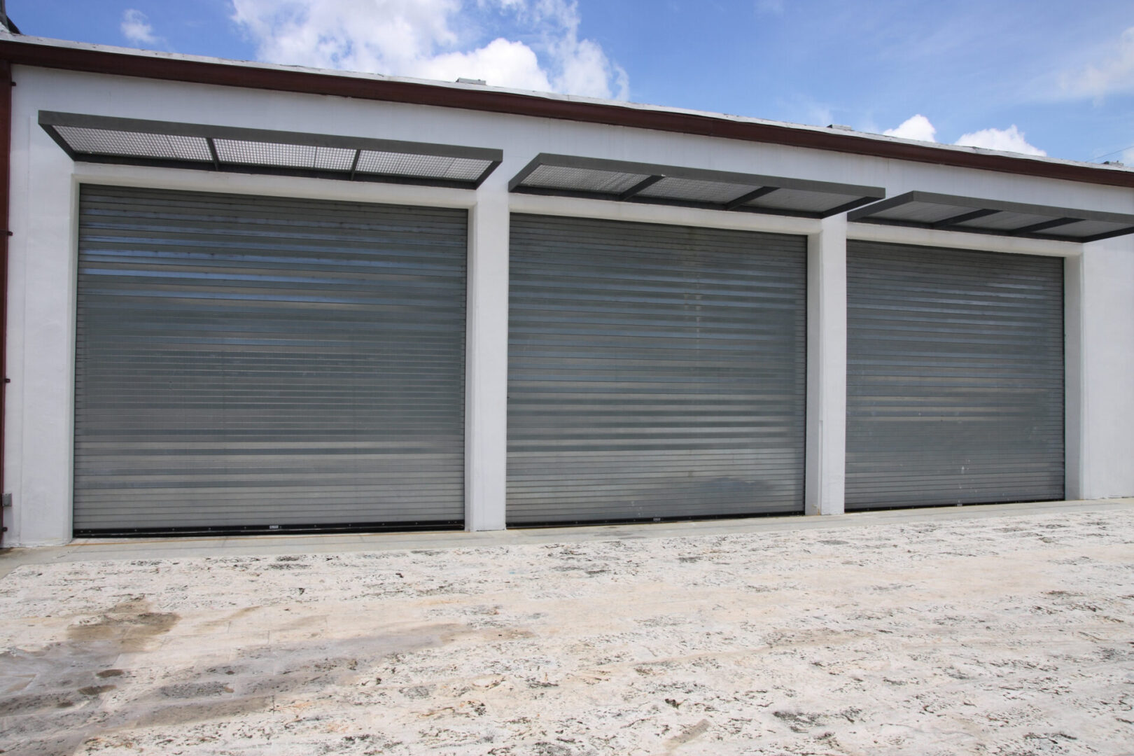 Three closed metal garage doors