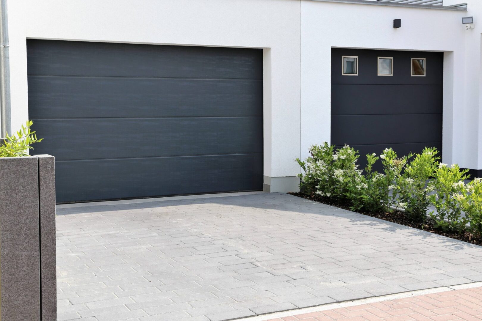 Contemporary garage with dark doors